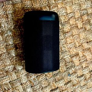 Black portable speaker with handle includes charger